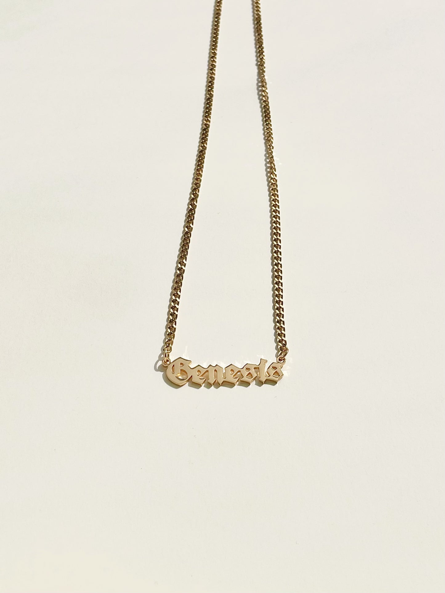 golden name necklace with goth style font and mini cuba chain
