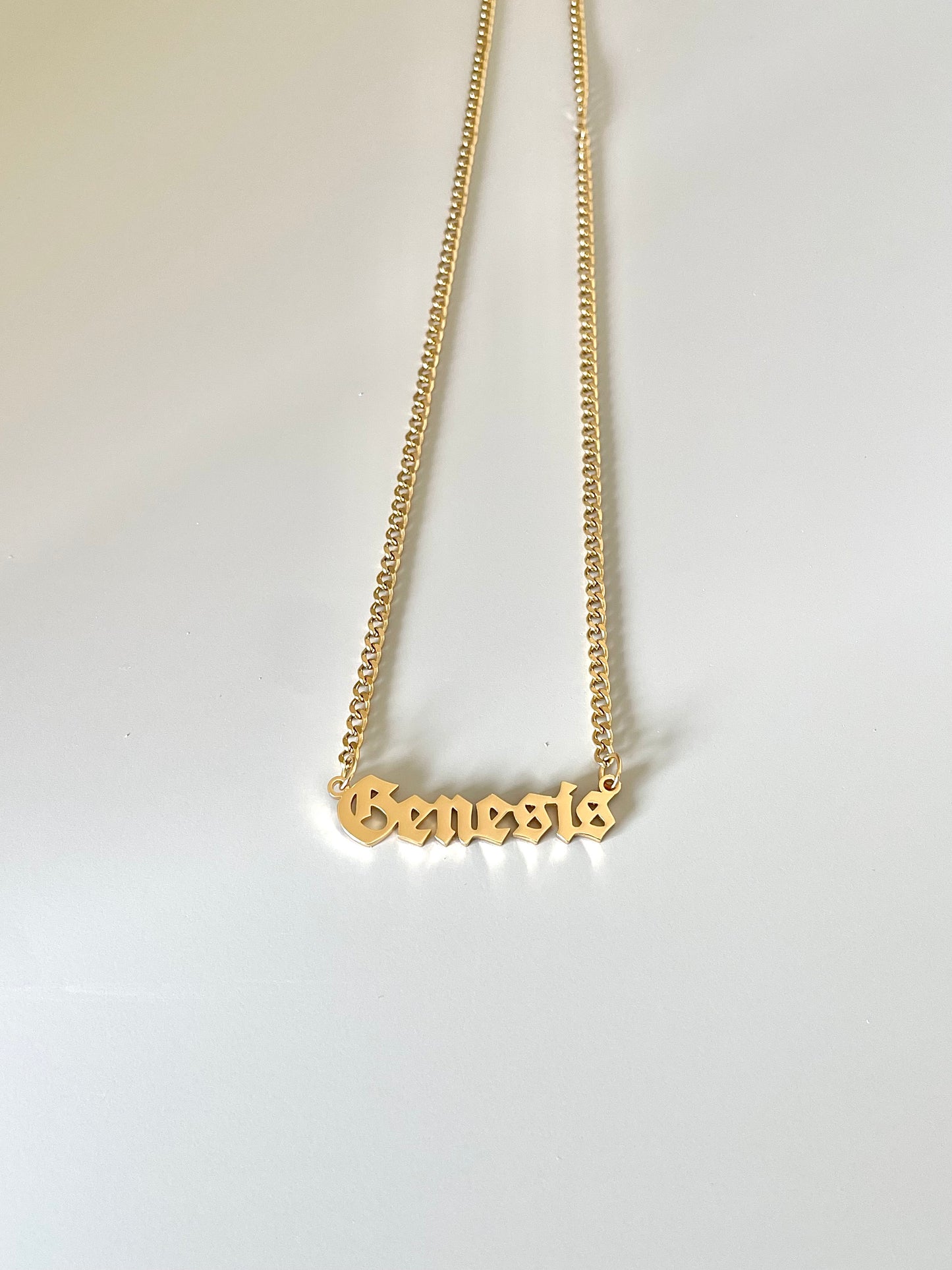 golden name necklace with goth style font and mini cuba chain