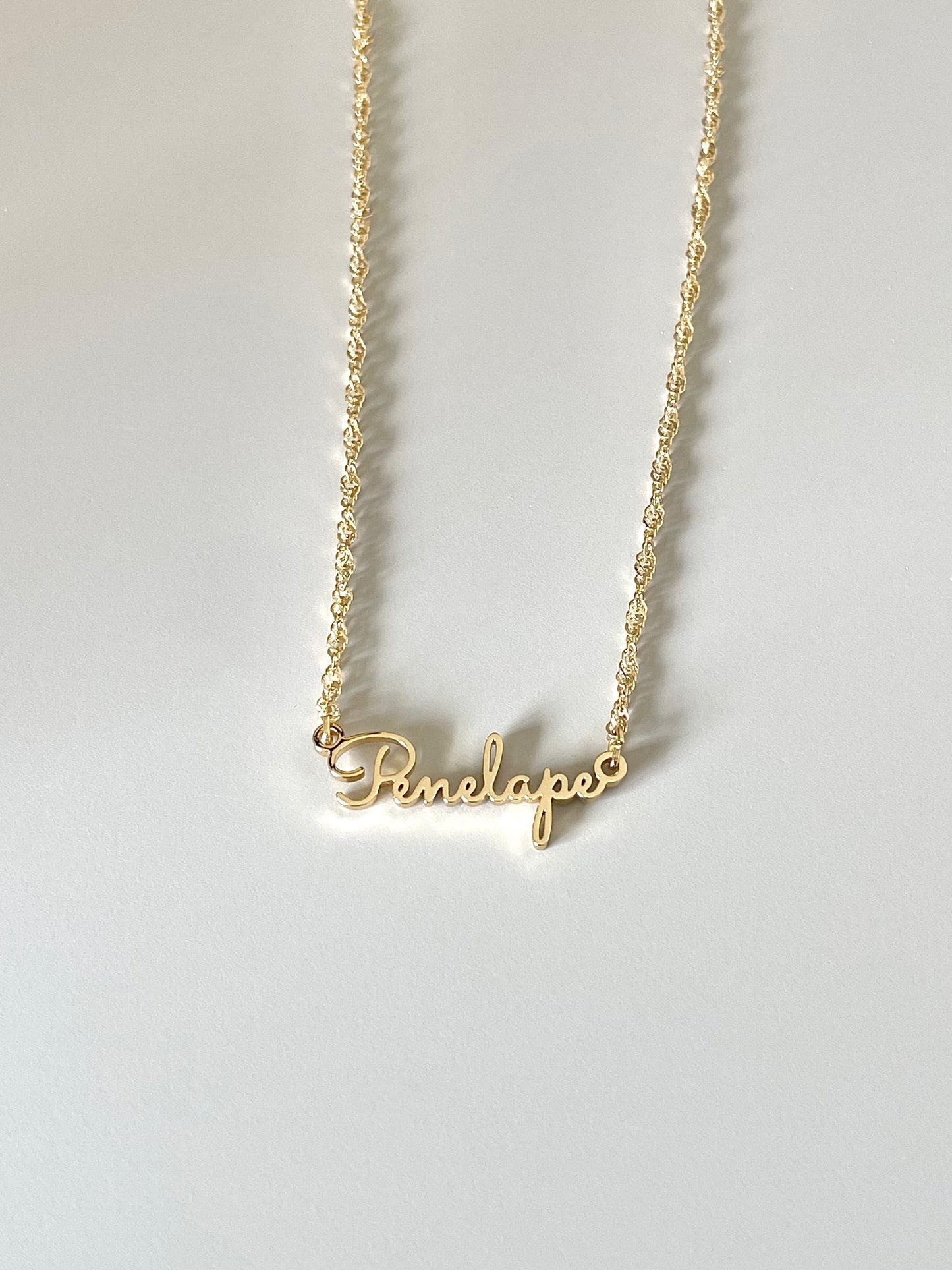 golden name necklace with calligraphy font and Singaporean chain
