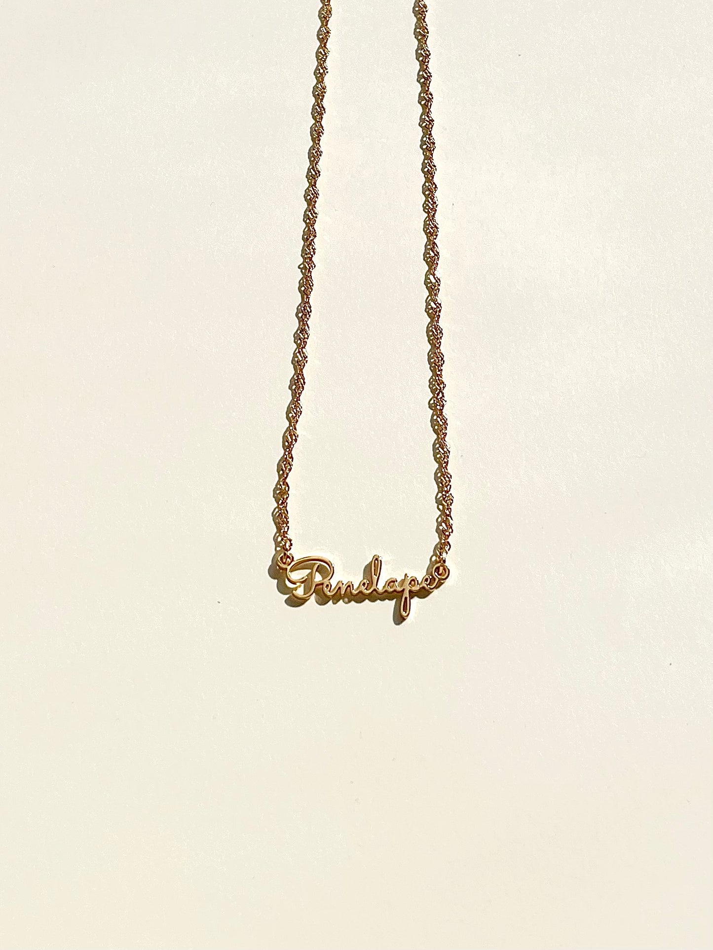 golden name necklace with calligraphy font and Singaporean chain