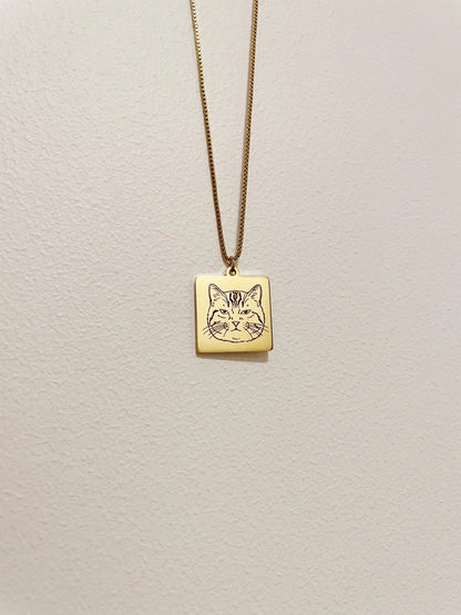 Custom gold pet memorial necklace with hand-traced portrait on a waterproof pendant, personalized cat jewelry.